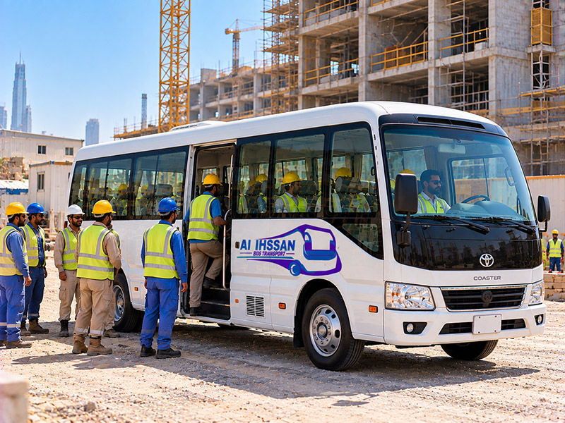 Bus collecting workers in hi-vis vests for a Sharjah labour shuttle